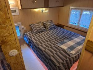 a bedroom with a bed in a small room at Mobile home style maisonnette de vacance in Méjannes-le-Clap +24 photos