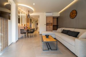 a living room with a couch and a table at The Mall Luxury Suites in Nikiti