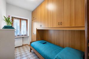 a bedroom with a bed and wooden cabinets at Ca' Due Cuori in Torri del Benaco