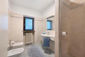 a bathroom with a shower and a toilet and a sink at Ca' Due Cuori in Torri del Benaco +31 photos