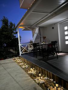 a patio with a table and chairs and rocks at Romeo apartament in Sarandë