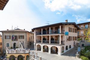 a large building with a balcony in a city at Residence Casa Gardola, GTSGroup in Tignale