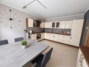 a kitchen with a table and chairs in a room at Sweet&City HOUSE in Saint-Vith