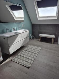 a bathroom with a sink and a bench and two skylights at Sweet&City HOUSE in Saint-Vith +12 photos