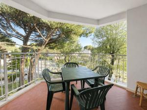 a patio with a table and chairs on a balcony at Appartamento Eunoia I TerraceParking&AC in Lignano Sabbiadoro