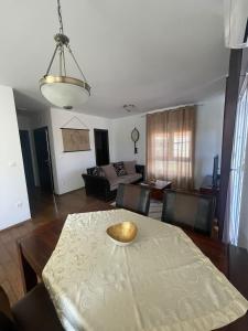 a living room with a table and a couch at My place Čiovo holiday house in Žedno