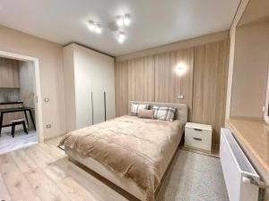 a bedroom with a bed and a desk in it at Voloshyna Central Loft in Ivano-Frankivsk