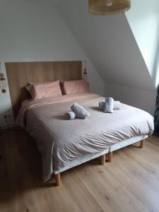 a bedroom with a bed with two pillows on it at Maison des bois in Neufchâtel-Hardelot
