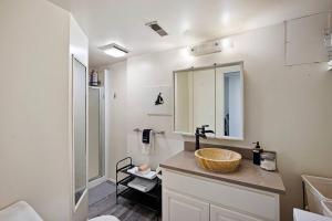 a bathroom with a sink and a mirror at Seatac Lake Cottage A2 in SeaTac +12 photos