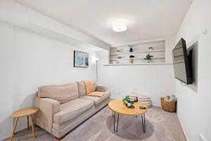 a living room with a couch and a table at Seatac Lake Cottage A2 in SeaTac