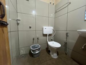 a bathroom with a toilet and a sink at S S Apartment in Kannur