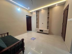 a room with a bed and a room with a door at S S Apartment in Kannur