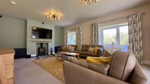 a living room with a couch and a fireplace at Fells in Chapel Stile