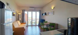 a living room with a couch and a table at Florence Garda Hotel in Manerba del Garda