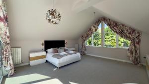 a bedroom with a bed and a large window at Fells in Chapel Stile