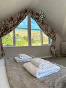 a bedroom with towels on a bed with a window at Fells in Chapel Stile +136 photos