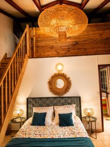 a bedroom with a bed with a wooden ceiling at Tidododesiles in Bouillante