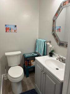 a bathroom with a white toilet and a sink at Surfer's Bungalow in San Diego +15 photos