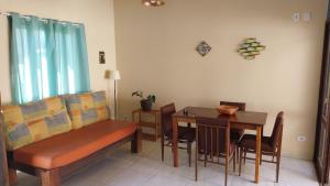 a living room with a couch and a dining room table at Sobrado entrada de Paraty in Paraty +7 photos