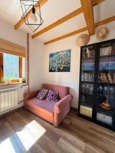 a living room with a couch and a book shelf at Nadbużańska Ostoja in Kamieńczyk