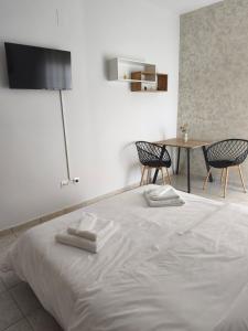 a bedroom with a bed with two towels on it at Lounetta Apartments 2 in Missolonghi
