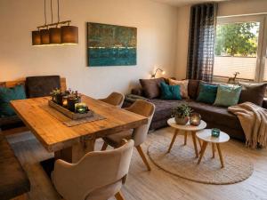 a living room with a table and a couch at MiraBlau Braunlage in Braunlage