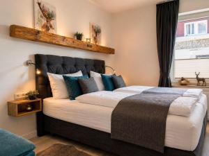 a bedroom with a large bed with blue pillows at MiraBlau Braunlage in Braunlage