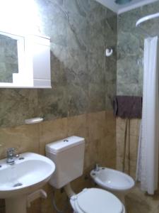 a bathroom with a toilet and a sink at Alojaserve in San Rafael