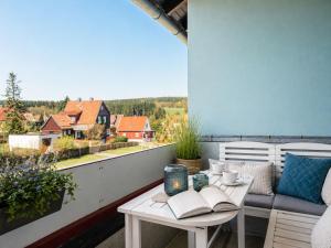 a balcony with a table with books on it at MiraBlau Braunlage in Braunlage
