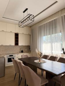 a kitchen and dining room with a table and chairs at Easy Stay in Karlovo +11 photos
