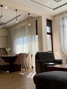 a living room with a couch and a table and chairs at Easy Stay in Karlovo