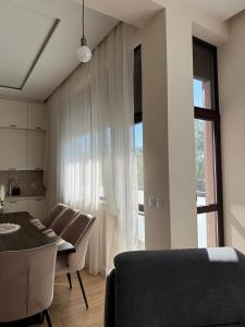 a living room with a dining table and a window at Easy Stay in Karlovo