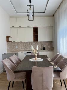 a kitchen with a dining room table and chairs at Easy Stay in Karlovo