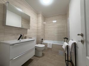 a bathroom with a toilet and a sink and a tub at IDDA Concept 1 in Târgu-Mureş +19 photos