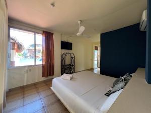a bedroom with a large bed and a large window at Casa Piedra Parada in Brisas de Zicatela