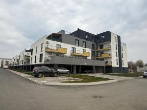 a large building with cars parked in a parking lot at IDDA Concept 1 in Târgu-Mureş