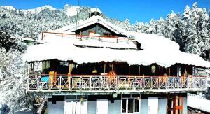 a building with snow on top of it at Casa Nova in Manāli +22 photos