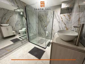 a bathroom with a glass shower and a sink at Hotel Santa Ana Luxury Rentals - 111 in Bogotá +15 photos