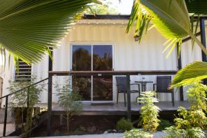 a house with a porch with a table and chairs at Garden to Table Experience - Unit 101 in Rincon