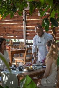 a man and a woman preparing food at a table at Garden to Table Experience - Unit 101 in Rincon