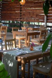 a table with a blue table cloth and wooden tables and chairs at Garden to Table Experience - Unit 101 in Rincon
