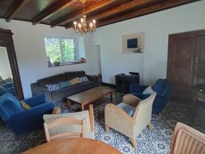 a living room with blue chairs and a couch at Kerispern-Ti Mestr in Trégunc