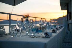 a long table with wine glasses and napkins on it at Bliss by the Sea in Ulcinj