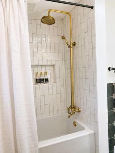 a bathroom with a tub and a shower curtain at Charming Home Downtown Paso Robles in Paso Robles +35 photos
