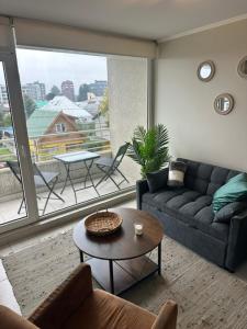 a living room with a couch and a table at LUGAnO 301 in Temuco