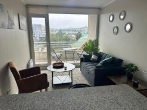 a living room with a couch and a table at LUGAnO 301 in Temuco