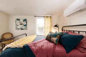 a bedroom with a large bed with pillows on it at Charming Home Downtown Paso Robles in Paso Robles