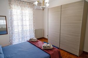 a bedroom with a bed with shoes on it at Gli agrumi di Nonna Peppina - Appartamento Limoni in Mondragone