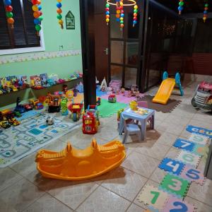 a childs play area with toys on the floor at Pousada Luar de Penedo in Penedo +60 photos