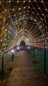 a tunnel with lights in a park at night at Pousada Luar de Penedo in Penedo